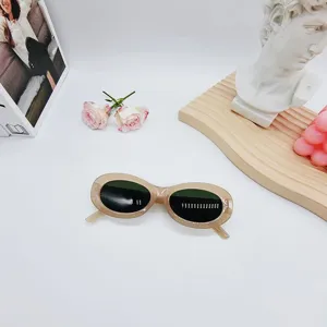 Trendy oval sunglasses for women, retro beige frame design, stylish summer eyewear accessory.