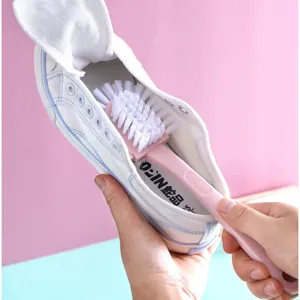 Handheld cleaning brush with durable white bristles for shoes, window grooves and home deep cleaning.