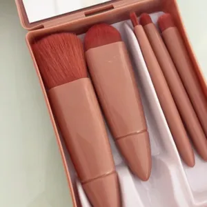 Portable travel 5-piece makeup brush set with mirror case, soft powder and blush brushes.