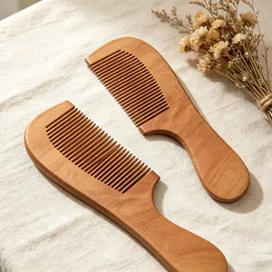 Close-up detail of smooth wooden hair combs on linen fabric background, natural wood.