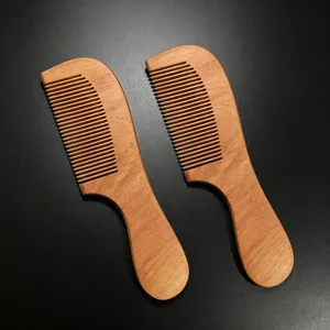 Detail shot of wooden hair combs showing fine teeth and natural grain texture, portable design.
