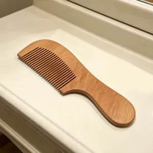 Portable wooden hair comb for daily use, smooth anti-static solid wood detangling tool.