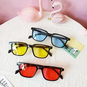 Detailed shot of trendy square sunglasses featuring colorful lenses and classic black frames.