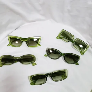 Detail view of stylish green transparent sunglasses in various trendy geometric shapes.