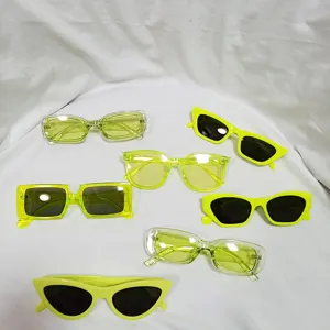 Detail view of assorted neon green jelly sunglasses, trendy vintage styles and colored lenses.