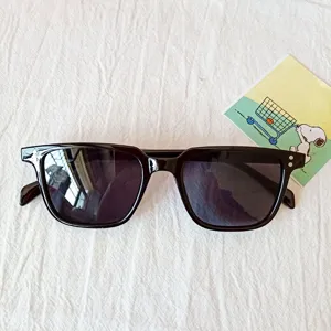 Detail shot of black retro square sunglasses with thick frames and stylish metal side accents.