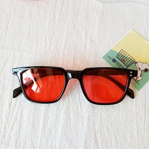 Black frame red lens square sunglasses stylish streetwear eyewear detailed close-up shot