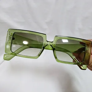 Green translucent square sunglasses detail shot, retro jelly frame summer fashion eyewear.