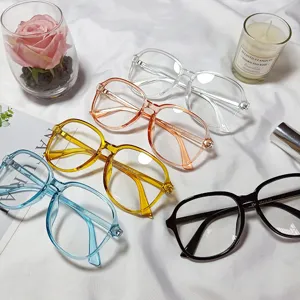 Detailed shot of multi-color large frame flat-top optical glasses arranged neatly on cloth.