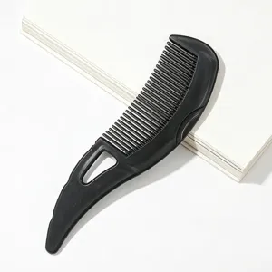 Black plastic hair comb detail view, scalp massage tool for daily styling and hair care.