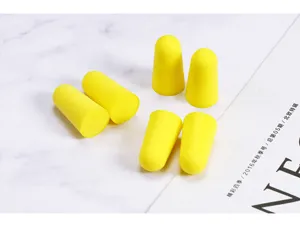 Soft foam noise-canceling earplugs detail shot, bullet shape for sleep and study use.