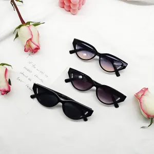 Detailed view of trendy retro cat eye sunglasses with chic notch design and colorful ocean lenses.