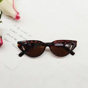Retro cat eye sunglasses with small tortoiseshell frame and dark lenses for women.