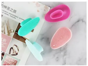 Silicone facial cleansing brush with soft bristles and ergonomic finger handle for daily skincare.