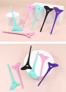 Detailed shot of colorful silicone eyelash assistant tools and eyeliner shields on stands.