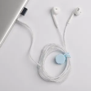 Multifunctional silicone magnetic cable tie and wired earphone set for neat desktop storage.