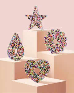 Close-up of colorful resin bead decompression toys in various shapes on pedestals.