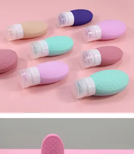 Silicone travel sub-bottle detail view, flexible squeeze lotion container in various colors.