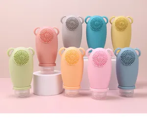 Silicone travel lotion bottle set with facial cleaning brush and cute bear ears design.