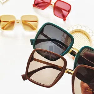 Detailed view of trendy square sunglasses for women, featuring gradient lenses and chic frames.