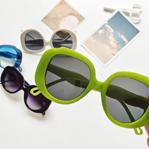 Detailed shot of trendy oversized round frame sunglasses in multiple vibrant colors for women.