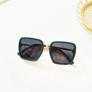 Detailed view of trendy green thick-frame square sunglasses with gradient lenses for women.