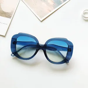 Oversized round sunglasses for women, gradient blue lenses, fashion retro eyewear frame.