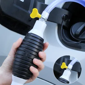 Manual car fuel siphon pump with rubber squeeze bulb and clear hoses for oil transfer.