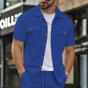 Detail view of mens waffle knit short sleeve shirt and shorts set in solid blue color design.