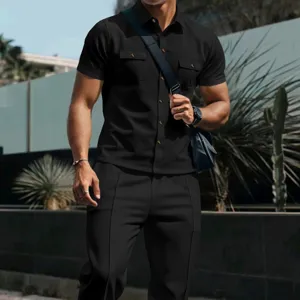 Detail shot of men's black waffle short sleeve shirt and trousers set with utility pockets.