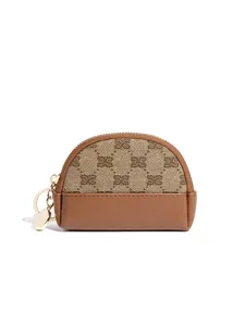Vintage mini half-moon coin purse with monogram canvas, leather trim, and zipper closure.
