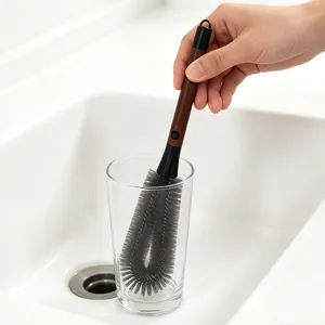 Detailed view of the multi-functional cup brush with walnut long handle cleaning bottles easily.