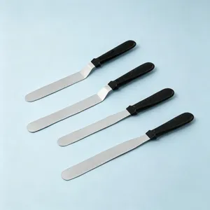 Stainless steel offset cake spatula set with black handles for baking and frosting details.