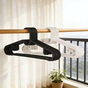 Black and white plastic clothes hangers, heavy-duty non-slip coat hangers for home storage.