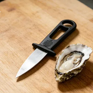 Stainless steel oyster knife with ergonomic handle for shucking seafood and barbecue tools.