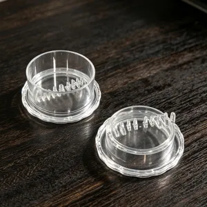 Closeup detail shot of transparent plastic garlic twister components for kitchen use.