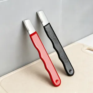 Close up detail of the manual knife sharpener highlighting its ergonomic handle and sharp edge.