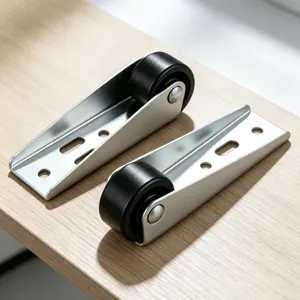 Detail view of metal door support rollers with black casters for sliding door hardware.
