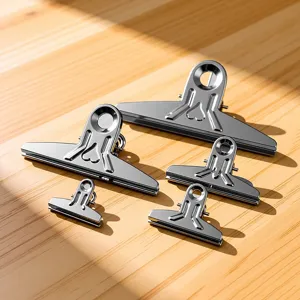 Stainless steel metal binder clips detail view, showcasing various sizes and heart cutout design.