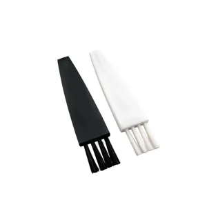 Dettaglio del set di mini spazzole in nylon nero e bianco per rasoi e tastiere.