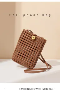 Woven cell phone bag detail showcasing intricate texture and gold ball clasp closure.