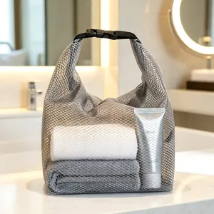 Portable grey mesh travel toiletry bag detail view, breathable storage pouch for gym and beach.