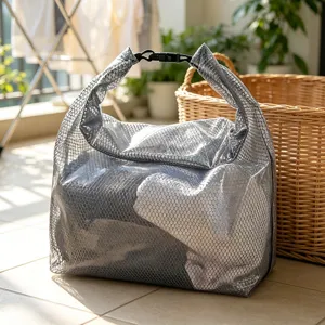 Detail view of waterproof mesh storage bag with roll-top buckle for travel or gym use.