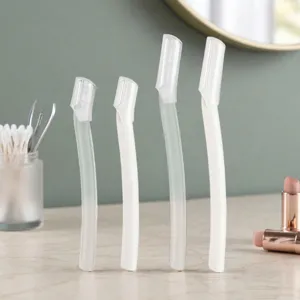 Close-up of portable safety eyebrow razors with protective caps for precise facial grooming detail.