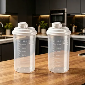 Clear plastic storage jar with white lid and scale markings for kitchen food organization.