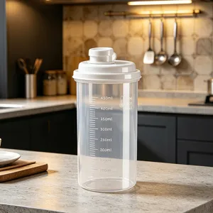 Transparent plastic storage container with white lid and scale marks for kitchen food use.