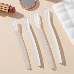 Detail view of safety eyebrow razors, featuring a set of four white micro-blade trimmers.