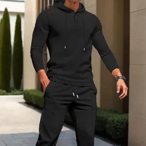 Detail view of men's black waffle knit hoodie and pants tracksuit set for stylish comfort.