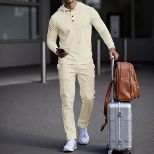 Casual men's waffle knit hoodie and matching pants set in light beige, perfect for stylish travel.