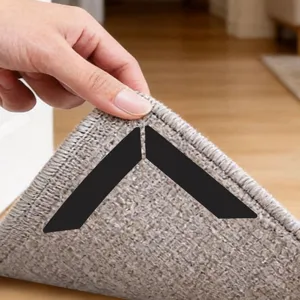 Detail view of triangular anti-slip carpet stickers, showing secure installation under mat corners.